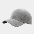 Detail of grey knitted baseball cap featuring a gold rhinestone star badge and soft wool texture - Adjustable / Gray