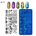 Macro view of rectangular nail art stamping plate with flower and butterfly patterns - Plant Leaf Butterfly Bird Style (BC-11)