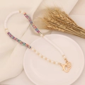 Detail of bohemian pearl and colorful polymer clay beaded necklace with gold heart clasp - Camouflage
