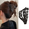 Detail view of a black metal skull hand hair claw clip and model wearing it for Halloween - 2# Black Skeleton Hand 10.5cm