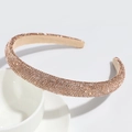 Detail view of champagne gold headband with luxury rhinestones on white ceramic bowl - Rose Gold