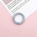 Detail shot of light blue metal spring ring buckle on a decorative card background - Gray