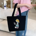 Black canvas tote bag with 'Nice Day' girl and cat illustration in a minimalist setting - Straw Hat Girl - Black