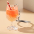 Luminous orange soda cup keychain with lemon slice and red striped straw in a wine glass - Red