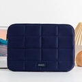 Detail of navy blue quilted laptop sleeve with premium leather brand label and secure zipper - 14" / Navy Blue