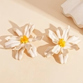 Detail of white acrylic flower earrings with yellow beaded stamens and a glossy finish - White Flower with Silver Needle / White