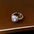 Macro shot of a classic circular halo ring with sparkling round cubic zirconia stones - Halo Round Style / Silver Round Style