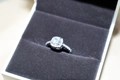 Macro view of square halo zircon ring with side stones in a velvet jewelry box - Square Zirconia Ring