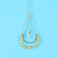Detail of golden crescent moon suncatcher with yellow stones and crystal drop charm - Citrine