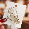 Detail of a golden skeleton hand hair clip with sparkling rhinestones on white card - Pink Skeleton Hand
