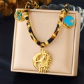 Leopard print cord necklace with vintage gold sun moon pendants on a jewelry stand - Heart Sun Rays Style (N3453)