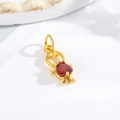 Detail view of a gold-plated small boy pendant with a red heart-shaped gemstone - Little Boy - Red Heart