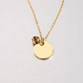 Close-up of golden necklace featuring a champagne gemstone and polished round pendant tag - 11# Birthstone