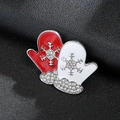Macro shot of festive red and white mitten Christmas brooch with rhinestone snowflakes - Silver Christmas Glove