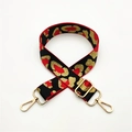 Detail of adjustable leopard print bag strap with red, black, and gold woven texture - Silver Clasp / Red