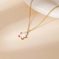 Golden necklace featuring a cute white gingerbread man pendant on a warm beige background - Red White Gingerbread Man Necklace