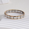 Detail of Italian charm bracelet links featuring embossed daisy patterns in gold and silver - Daisy Gold Edge (BD-97)