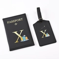 Close-up of black PU leather passport holder and luggage tag set with golden letter X - Black Letter X