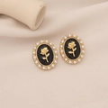 Vintage gold rose earrings with black enamel and white pearls on elegant white fabric - Black