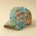 Macro detail of rhinestones and white pearls on tropical floral print baseball cap - One Size / Green
