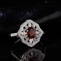 Macro shot of S925 silver ring with red oval garnet and surrounding white diamonds - Natural Garnet High-End Ring LR312