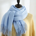 Sky blue long scarf with fine tassels shown on a mannequin with a yellow knit sweater - Light Blue