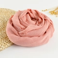 Soft coral pink linen scarf with frayed edges displayed in a floral spiral arrangement - 190x100cm / Pink