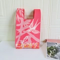 Detail of pink knitted tote bag featuring Spring text and swallow bird embroidery - Spring Swallow Pink