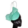 Vintage mint green fascinator hat with elegant mesh bow on a model head stand - Emerald Green