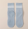 Detailed view of blue mid-calf yoga socks with white stripes and non-slip silicone grip - One Size / Light Blue