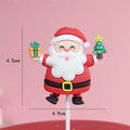 Santa Claus cake topper holding a gift box and tree for festive baking decoration - Santa with Gift Box and Tree