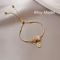 Elegant gold snake chain bracelet with diamond beads and heart pendant in alloy finish - Gold (Alloy Style)