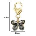 Black and white butterfly keychain charm with golden heart clasp and dimensions 4.5cm by 2.2cm - Black