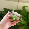 Brown Korok silicone case for AirPods with green leaf mask and metal carabiner - Haha + Carabiner / AirPods 1/2 Gen