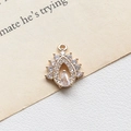 Detailed close-up of a golden teardrop pendant with zircon stones and a circular hanging loop - 7# Teardrop Shape