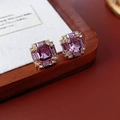 Macro shot of square gold earrings featuring purple octagonal gems and clear zircons - Purple (Silver Earring Post)