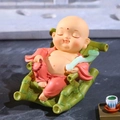 Cute Zen monk figurine sitting on a green bamboo rocking chair with Ruyi and prayer beads - 1222-5 Green Rocking Chair Monk