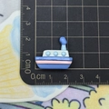 Blue resin ocean boat accessory showing exact 2cm size on a metric measurement grid - Blue Ship