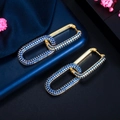 Detailed macro view of 18K gold plated clasp earrings featuring deep blue zircon stones - Gold Blue Zirconia