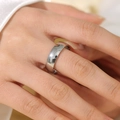Minimalist polished silver stainless steel ring displayed on a finger in macro detail - US 7 / Silver