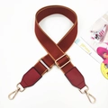 Detail of reddish-brown wide fabric strap with red leather ends and gold metal hooks - Wine Red & Brown with Wine Red