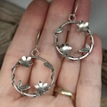 Vintage silver hollow vine earrings with flowers and leaves displayed on a hand - Floral Vine (5)