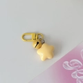 Macro detail of yellow star keychain featuring matching bell and metallic D-ring clasp - Yellow