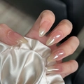 Detail of long oval press-on nails with nude gradient and rhinestone on silk background - By1593 Milky White Aurora / Glue Type