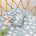Grey-blue muslin swaddle blanket with white ocean theme print on rattan background - Marine Life (S156)