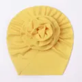 Detailed view of yellow ice silk baby turban featuring a large layered fabric flower - Yellow