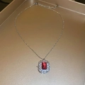Detailed shot of a vintage red emerald-cut zircon pendant on a gold chain necklace - Rose Red Square Zircon Necklace
