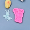 Pink silicone mold with rabbit and carrot shapes next to a blue finished bunny figure - Rabbit Holding Flower Style (3)