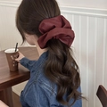Elegant wine red leather hair scrunchie with pleated texture shown in hair - Leather Ruffled Style (HH6870) / Burgundy