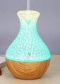 Macro detail of wood grain vase humidifier featuring a teal LED glow and crackle texture - USB Powered / Light Crackle
